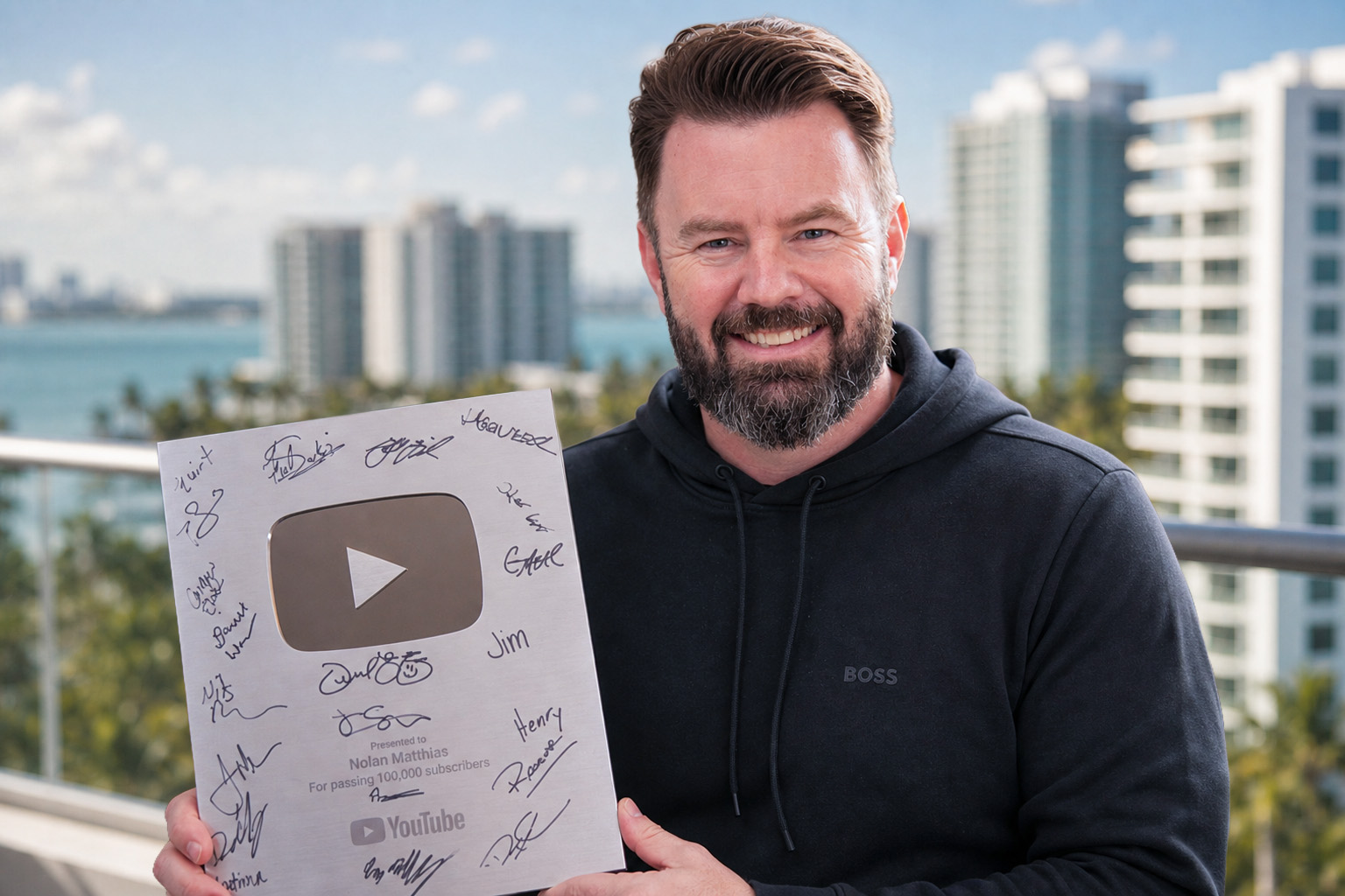 Nolan Matthias holding his signed YouTube Silver Play Button award for passing 100,000 subscribers